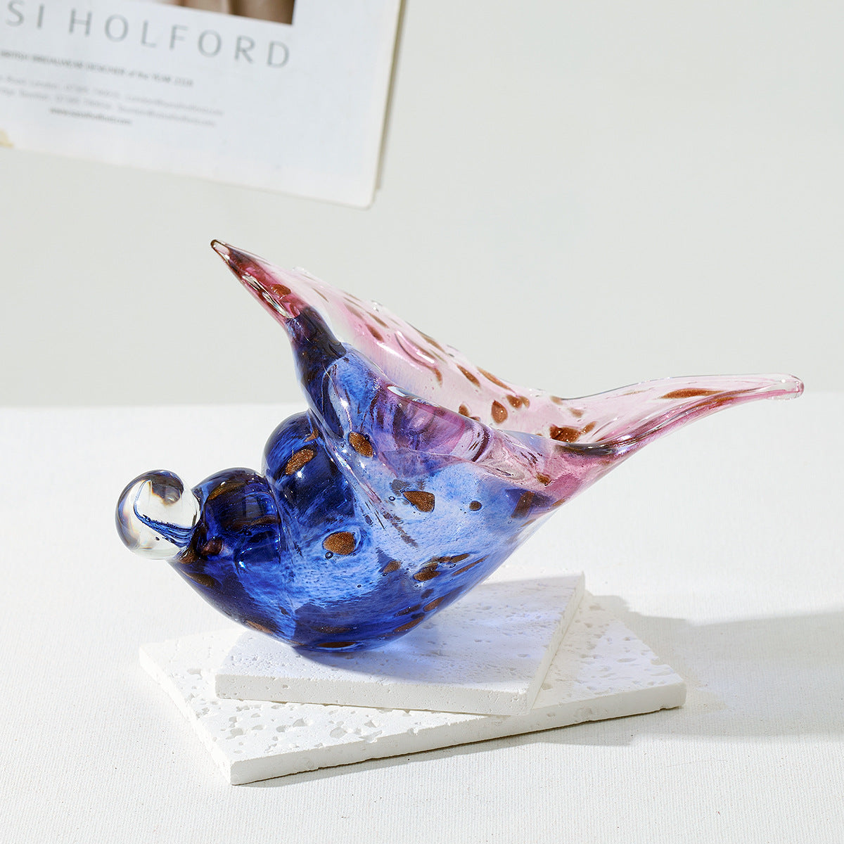 Blue and pink glass conch shell sculpture with spotted details