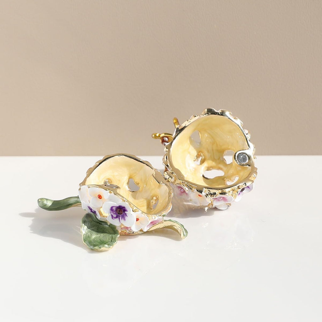 Floral enamel jewelry box shown open with gold-toned interior