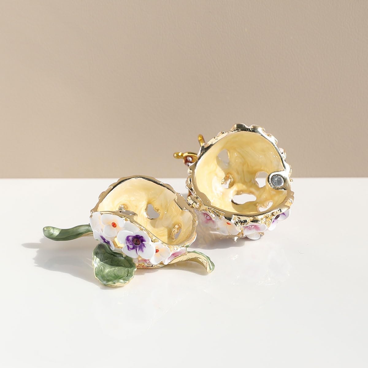 Floral enamel jewelry box shown open with gold-toned interior