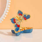 Butterfly jewelry box shown open with gold-toned interior