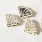White, pink, and black piano-shaped jewelry box designs viewed from above