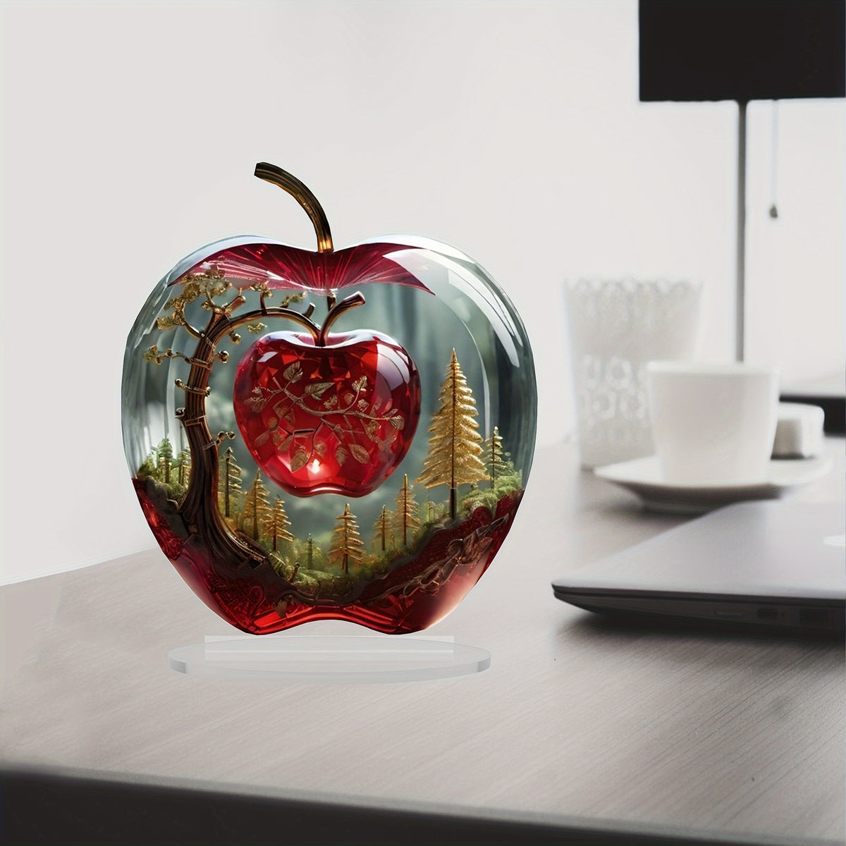 Apple-shaped acrylic ornament styled on an office desk