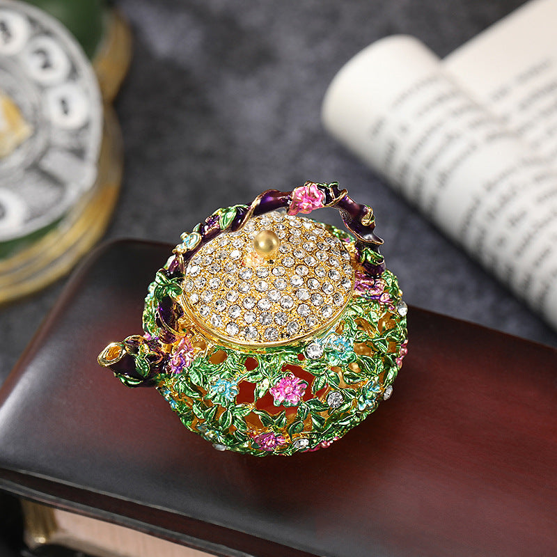 Top view of sparkling lid on a floral enamel teapot box