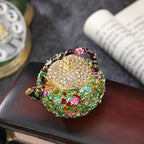 Top view of sparkling lid on a floral enamel teapot box
