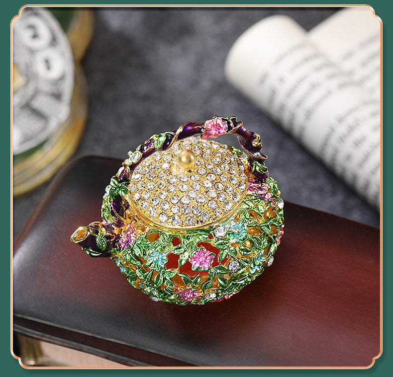 Framed product photo of floral enamel teapot box on a tabletop