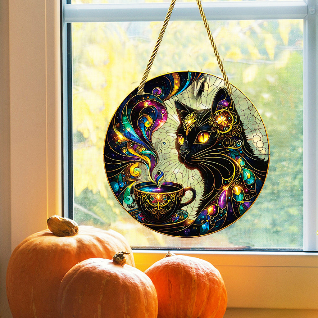 MoonCat hanging ornament displayed by a window with pumpkins