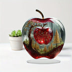 Forest apple acrylic ornament beside a small potted plant