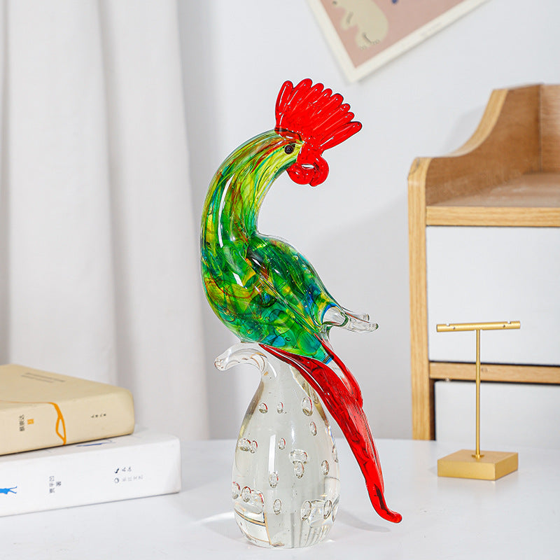Green and red glass rooster figurine on a clear rounded base