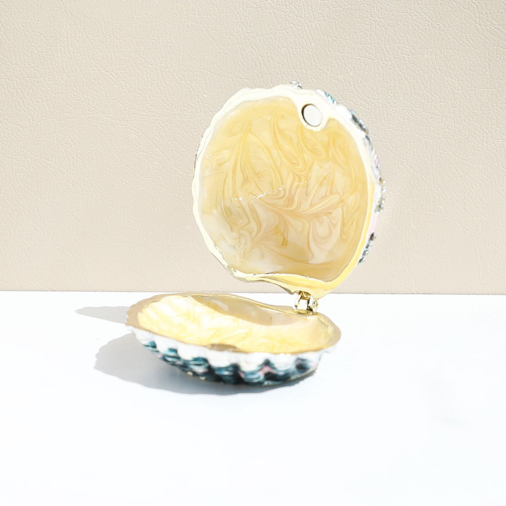 Open shell jewelry box showing its pale yellow interior