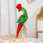 Glass rooster figurine displayed on a stack of books