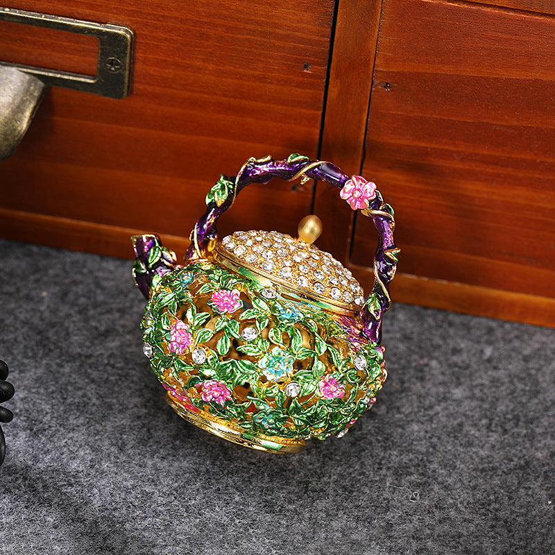 Floral teapot box displayed beside a wooden cabinet