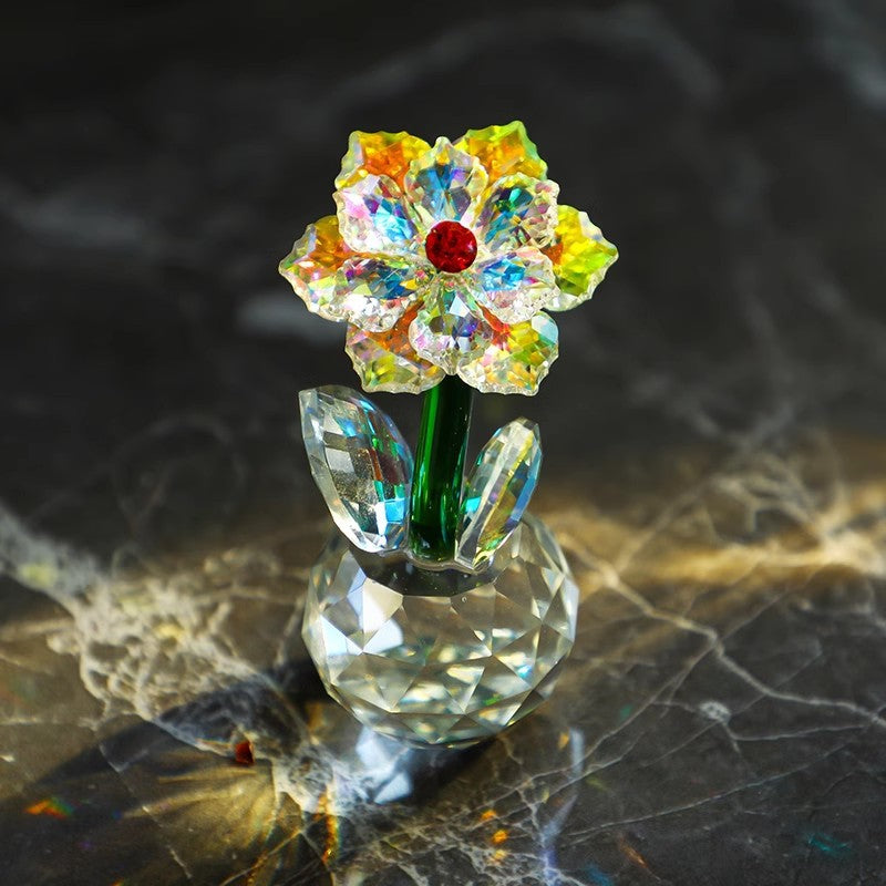 Sunflower glass ornament on a dark patterned surface