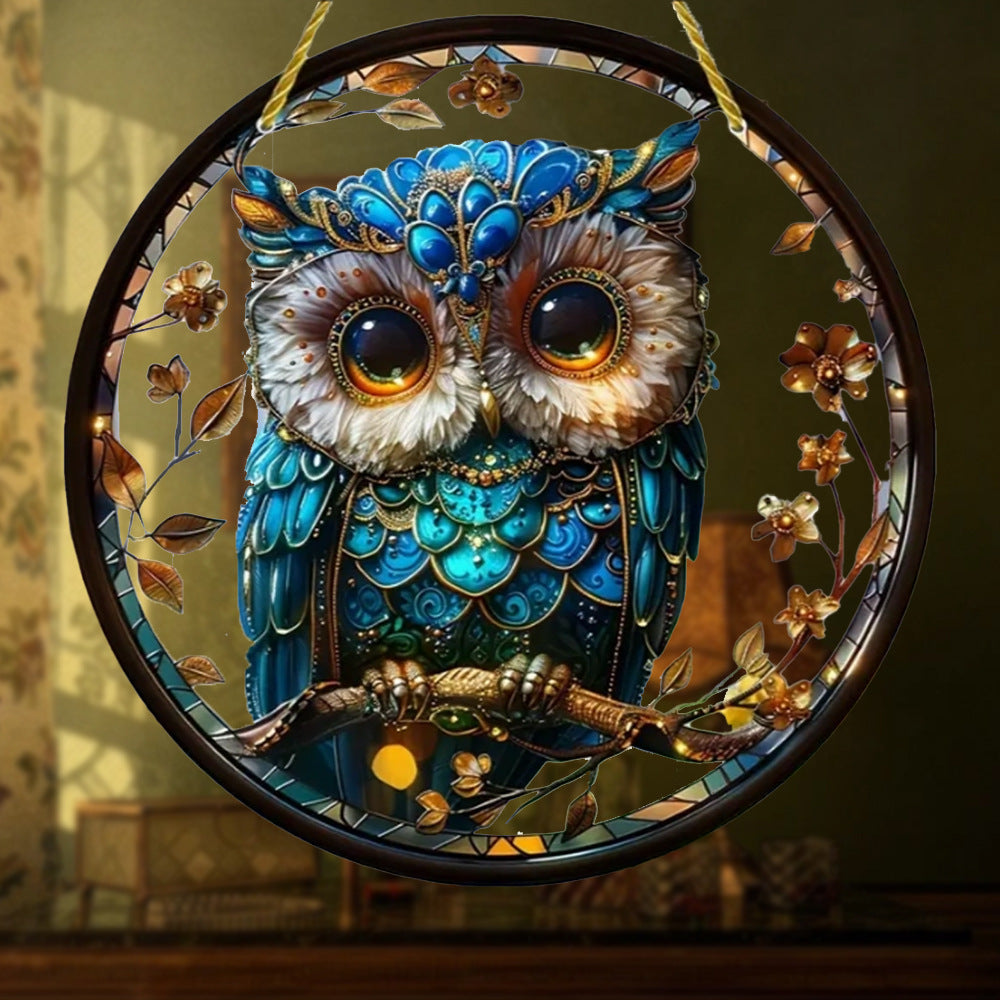Owl and floral artwork on a round hanging ornament