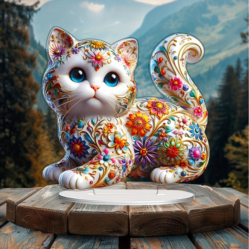 Floral kitten acrylic ornament with mountain scenery behind it