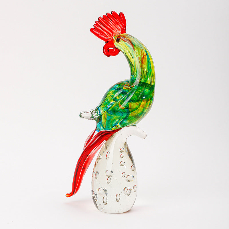 Side view of colorful glass rooster figurine on white background