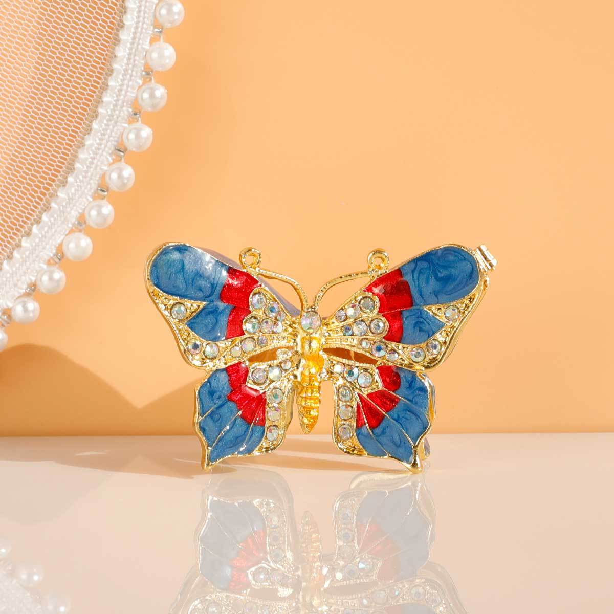 Butterfly jewelry box displayed upright on a reflective surface