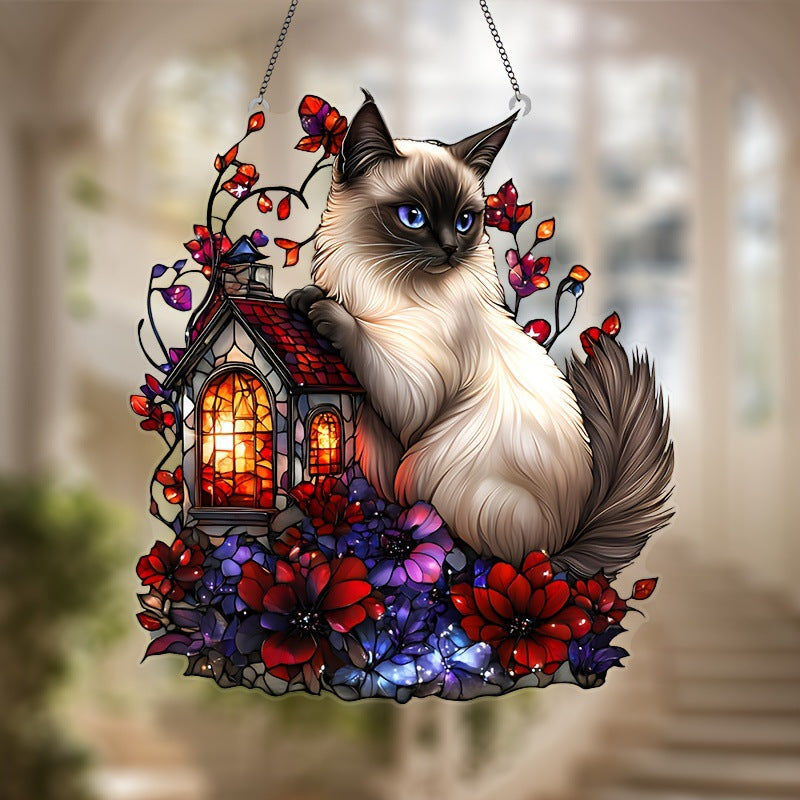 Close view of Siamese cat and cottage artwork on a hanging ornament