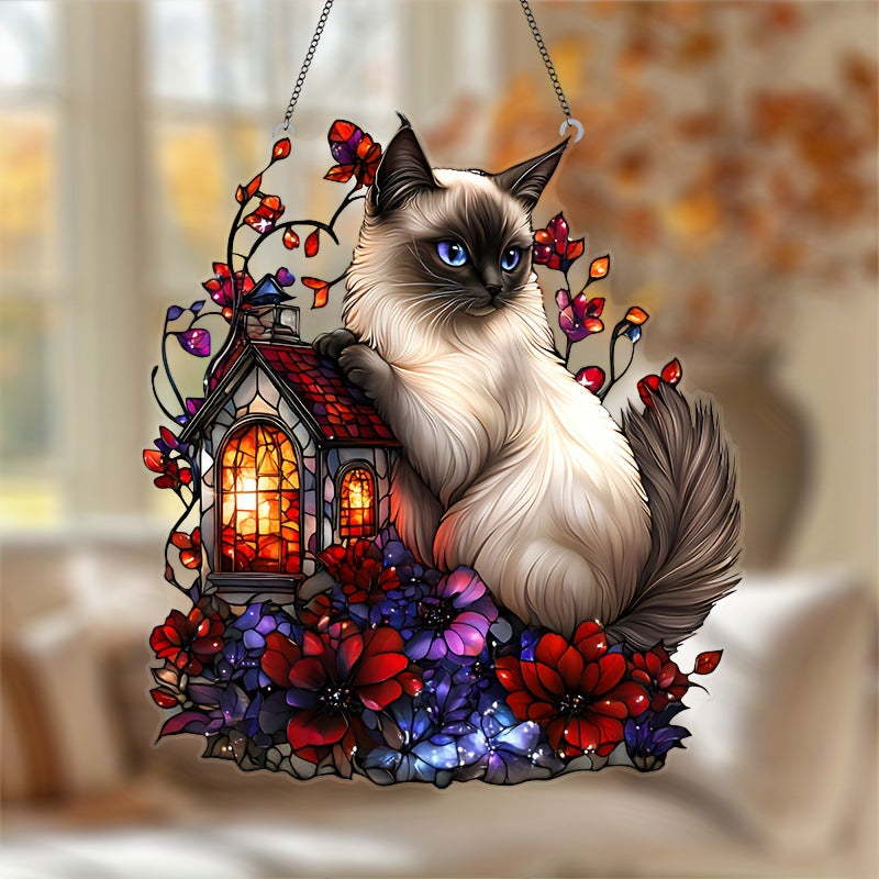 Blue-eyed Siamese cat hanging decoration displayed by a window