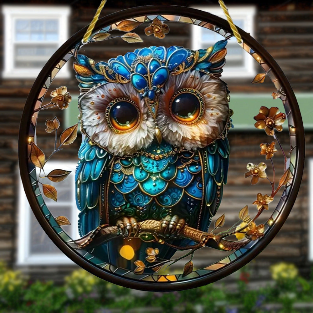 Blue owl acrylic hanging ornament displayed by a window