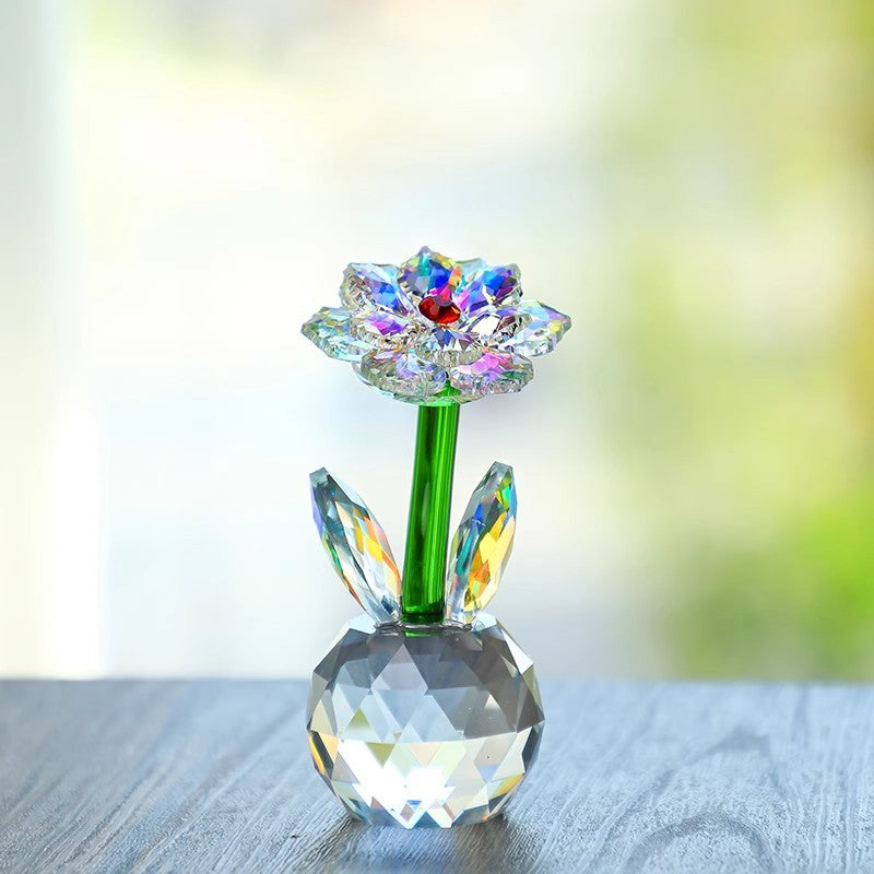 Sunflower glass ornament on fabric near a window