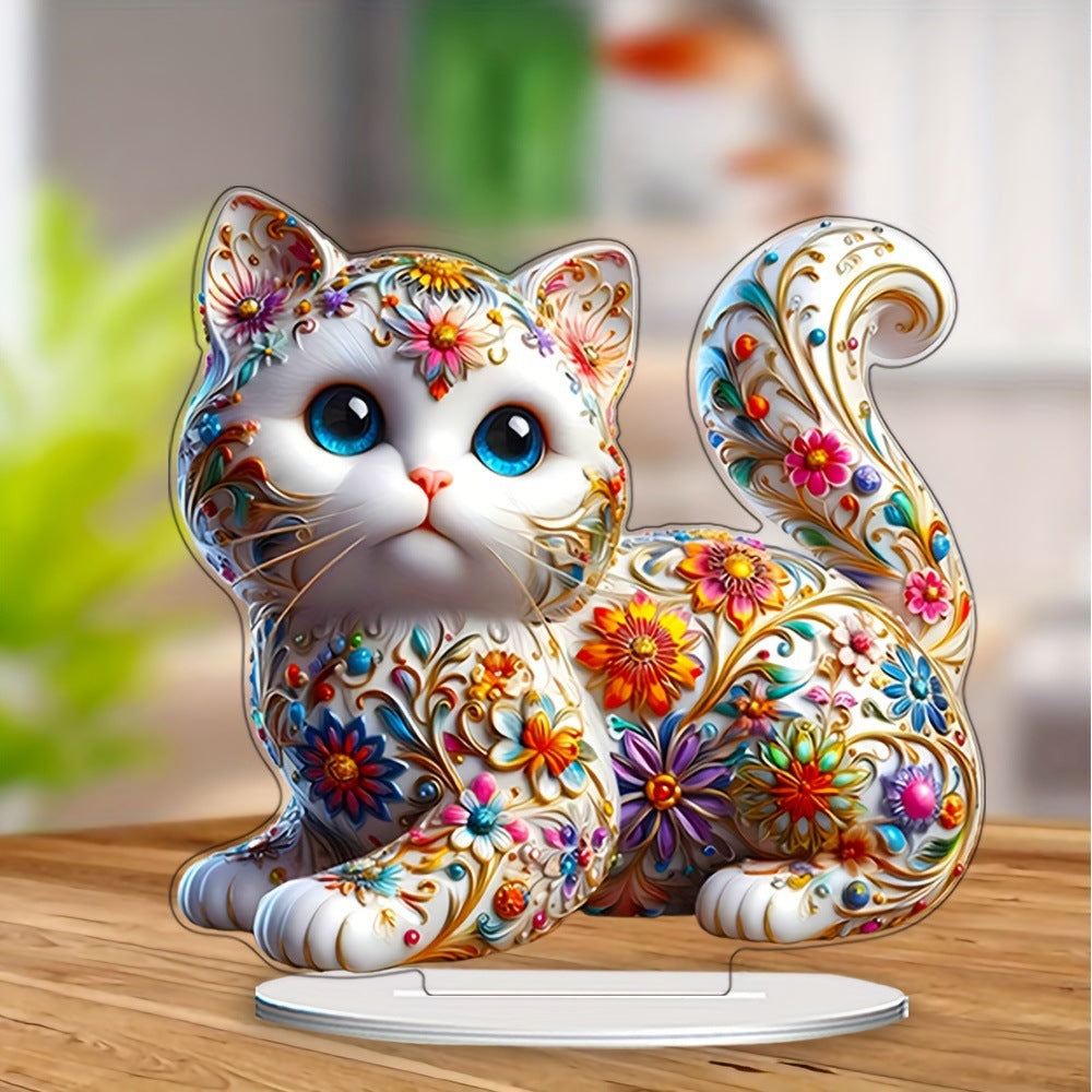 Blue-eyed floral kitten ornament on a wooden tabletop