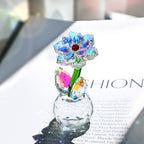 Faceted sunflower glass ornament with green stem on a magazine