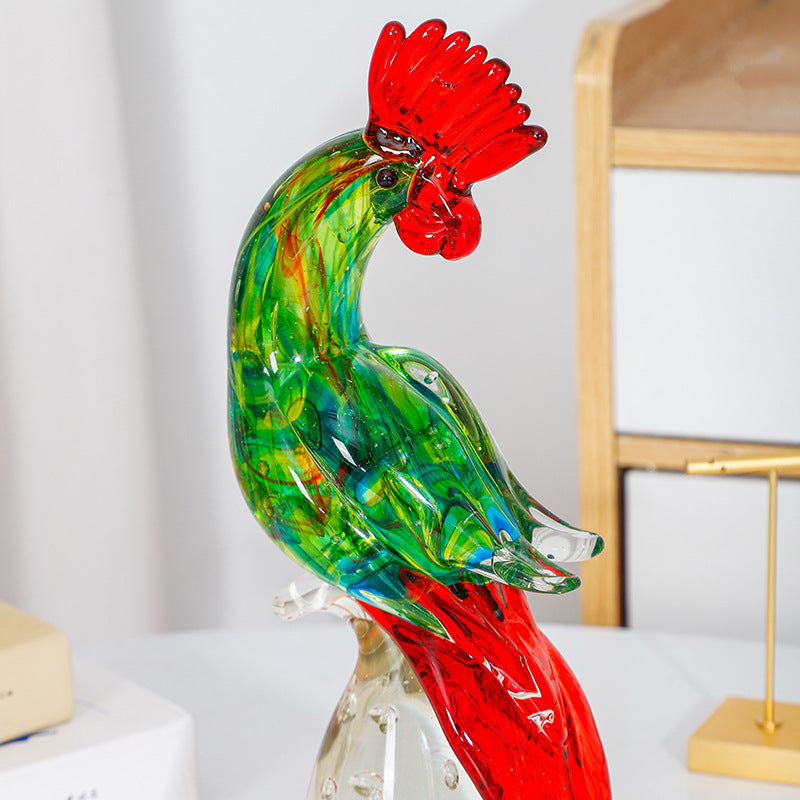 Close view of green glass rooster figurine with red crest and tail