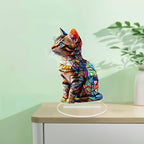Colorful cat acrylic tabletop ornament against a pale green background