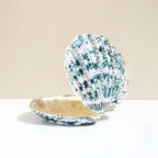 Green shell-shaped enamel jewelry box shown open