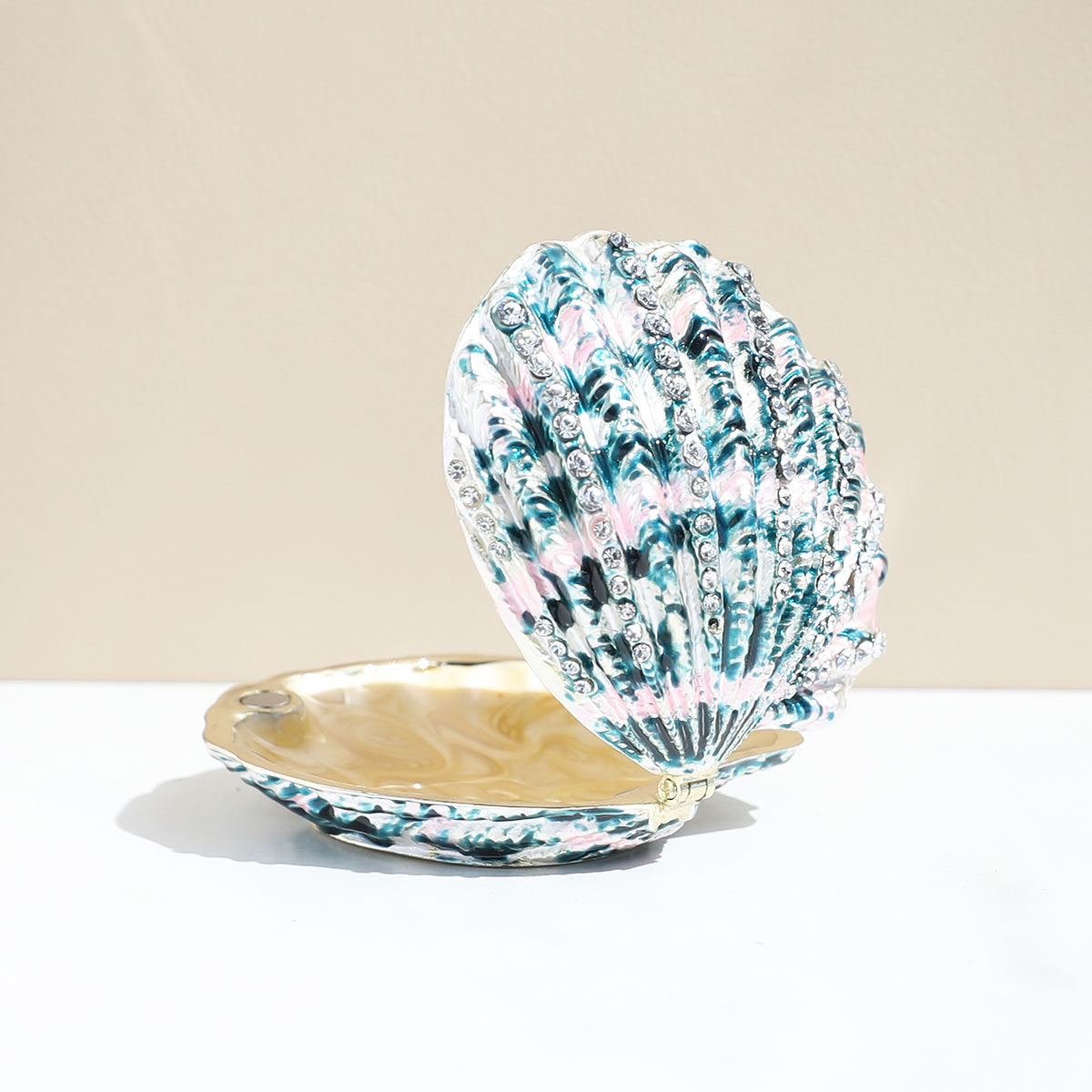 Green shell-shaped enamel jewelry box shown open